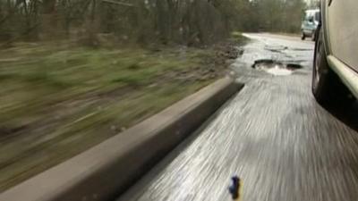 Car approaching a pothole