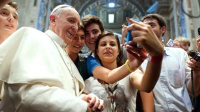 Pope Francis takes a 'selfie' with young Catholics