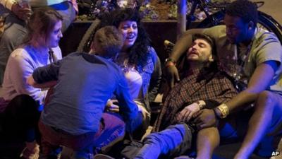 People comfort a man on the floor