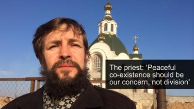 Priest outside church