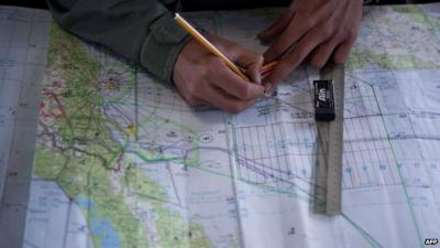 Royal Malaysian Air Force Navigator captain marks locations on a map