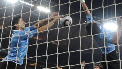 Uruguay's Luis Suarez handles the ball on the line against Ghana