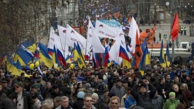 Demonstrators carrying Russian and Ukrainian flags march to oppose President Vladimir Putin's policies in Ukraine, in Moscow.