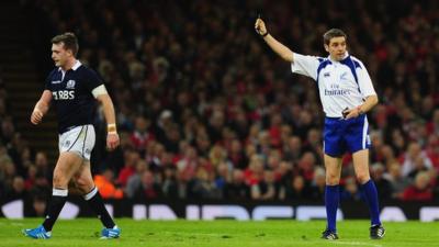 Scotland's Stuart Hogg is shown a red card for a late hit on Wales' Dan Biggar at the Millennium Stadium on Cardiff.