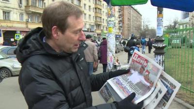 Richard Galpin looking at newspapers