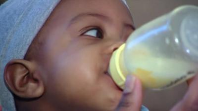 A baby being fed with a bottle