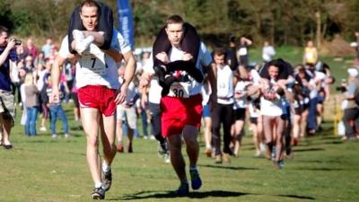 Competitors at the UK Wife Carrying Race 2014