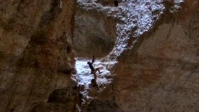 Man climbing in cave in Oman