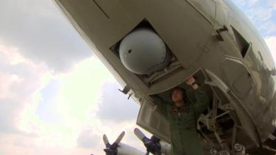 Camera under belly of P-3 Orion aircraft