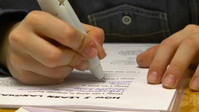 A child using a vibrating pen