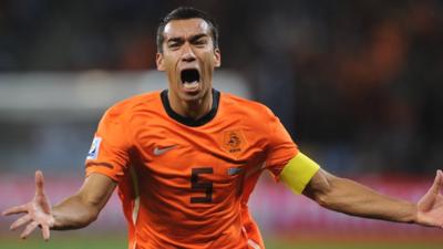 Giovanni van Bronckhorst celebrates after scoring for Netherlands against Uruguay