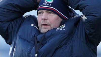 Linfield manager David Jeffrey talks to referee Colin Burns