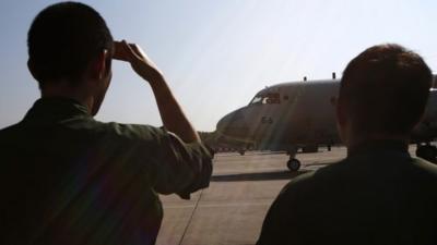 Japan Maritime Self-Defence Force personnel prepare to send off two Lockheed P-3C Orion aircrafts to Australia