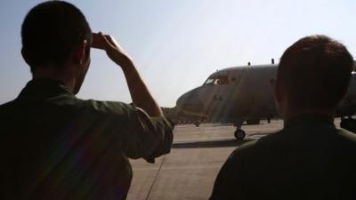 Japan Maritime Self-Defence Force personnel prepare to send off two Lockheed P-3C Orion aircrafts to Australia