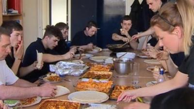 Trainees eating a curry