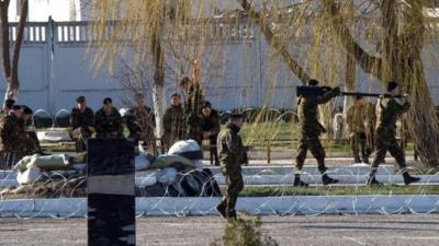 Ukrainian soldiers load weapons and amunition into trucks at the Ukrainian marine battalion in the Crimean city of Feodosia on March 23, 2014