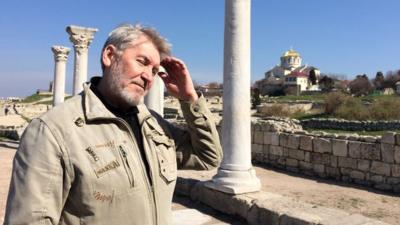 Man looking at ruins