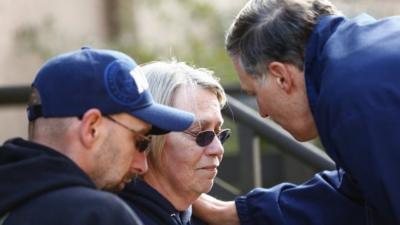 Washington Governor Jay Inslee talks privately with two residents personally affected by the mudslide