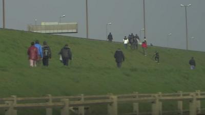 Illegal migrants trying to board UK-bound lorries in Calais