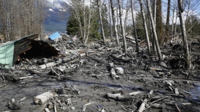 A house is seen destroyed in the mud on Highway 530 next to mile marker 37 on Sunday, March 23, 2014, the day after a giant landslide occurred near mile marker 37 near Oso