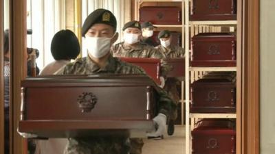 South Korean soldiers carrying coffins