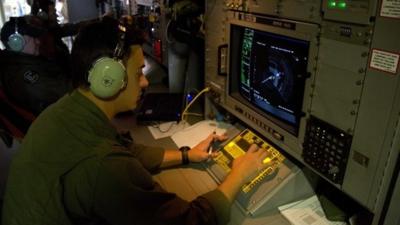 Electronics analyst on board Australian Air Force aircraft observes a radar image