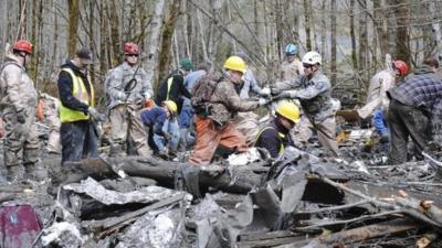 Personnel from the Washington National Guard join civilian workers in efforts to find the missing