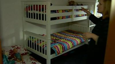 Women in bedroom with three beds