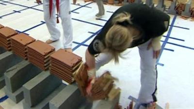 Woman smashing tiles in world record challenge