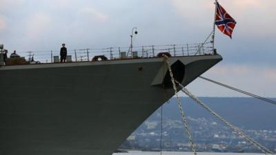 A sailor stands onboard a Russian Navy vessel anchored at a navy base in the Ukrainian Black Sea port of Sevastopol