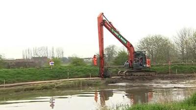 Vehicle dredging river