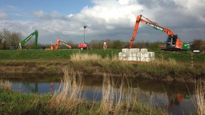 Dredging equipment beside a Somerset river