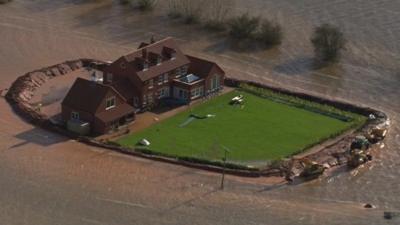 A house surrounded by flood water