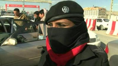 An Afghan Police woman at a security checkpoint in Kabul