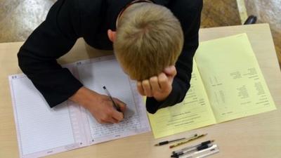 White boy taking a GCSE maths exam