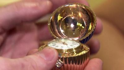 Faberge egg open to reveal watch face