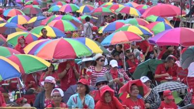 Pro-government supporters with coloured umbrellas in Bangkok