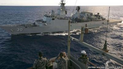 Crew aboard the Australian Navy ship HMAS Success look over to the Royal Malaysian Navy ship KD LEKIU during a Replenishment at Sea evolution in the southern Indian Ocean