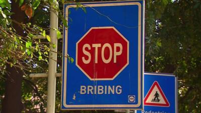 Stop bribing signpost