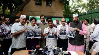 Leaders of Aam Aadmi Party holding their manifesto