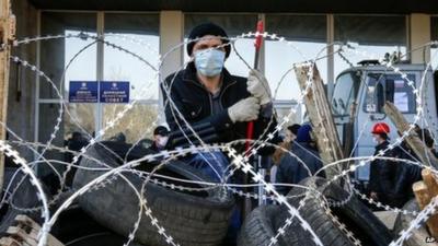 Pro-Russia masked man on barricade in Donetsk