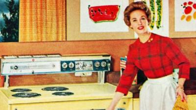 Woman standing by a stove