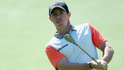 Rory McIlroy chips to the first green in Thursday's first round at the Masters