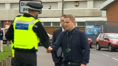 Police and staff outside one of 12 schools under investigation by Birmingham City Council and Ofsted