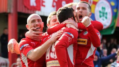 Cliftonville players celebrate with goal scorer Joe Gormley