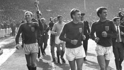 Bobby Moore and Geoff Hurst celebrate with the World Cup trophy in 1966