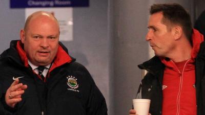 Linfield manager David Jeffrey and Stephen Baxter of Crusaders