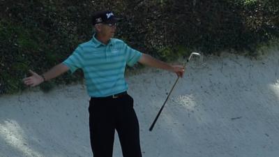 Former Masters champion Larry Mize holes a bunker shot