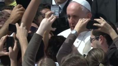 Pope Francis poses for selfies with crowds in Rome