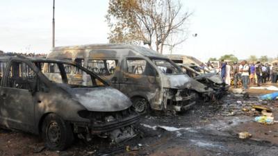 People gather at the site of the blast at the Nyanya Motor Park, 14 April